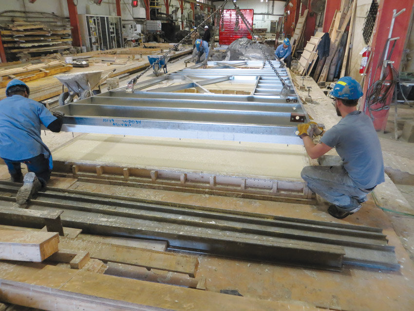 Image of workers working on factory-built panelized enclosures