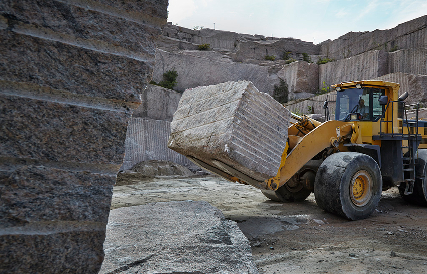 Bulldozer lifting heavy stone