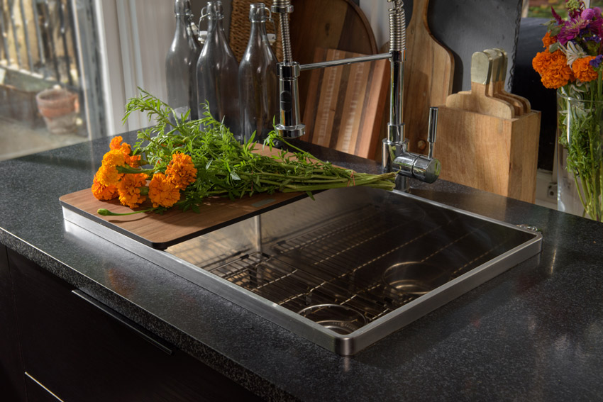 At Miller Residence, there is a sink that has built-in accessories that helps maximize space in the kitchen